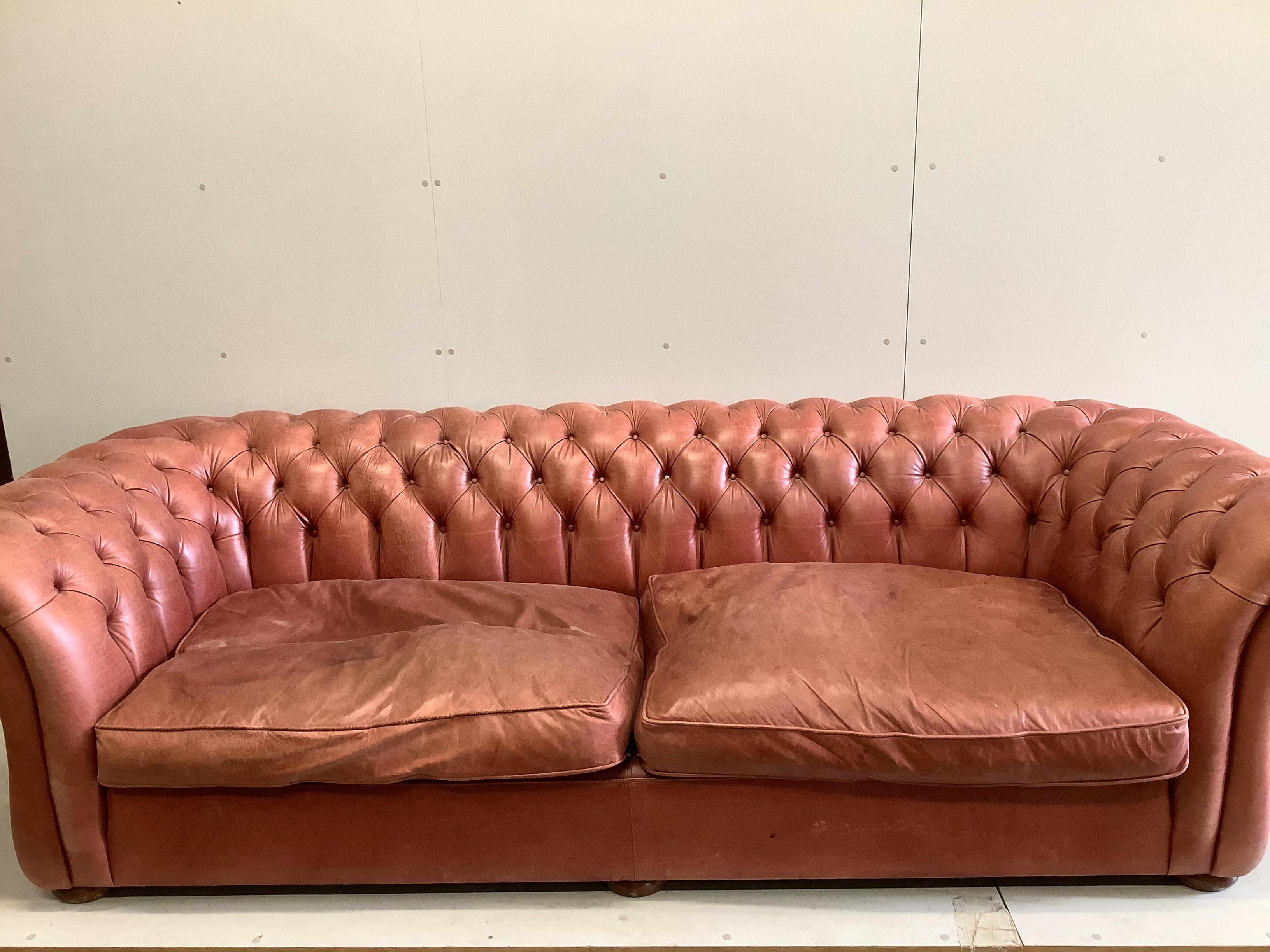 A large Victorian style buttoned back pale red leather Chesterfield settee, width 270cm, depth 104cm, height 76cm